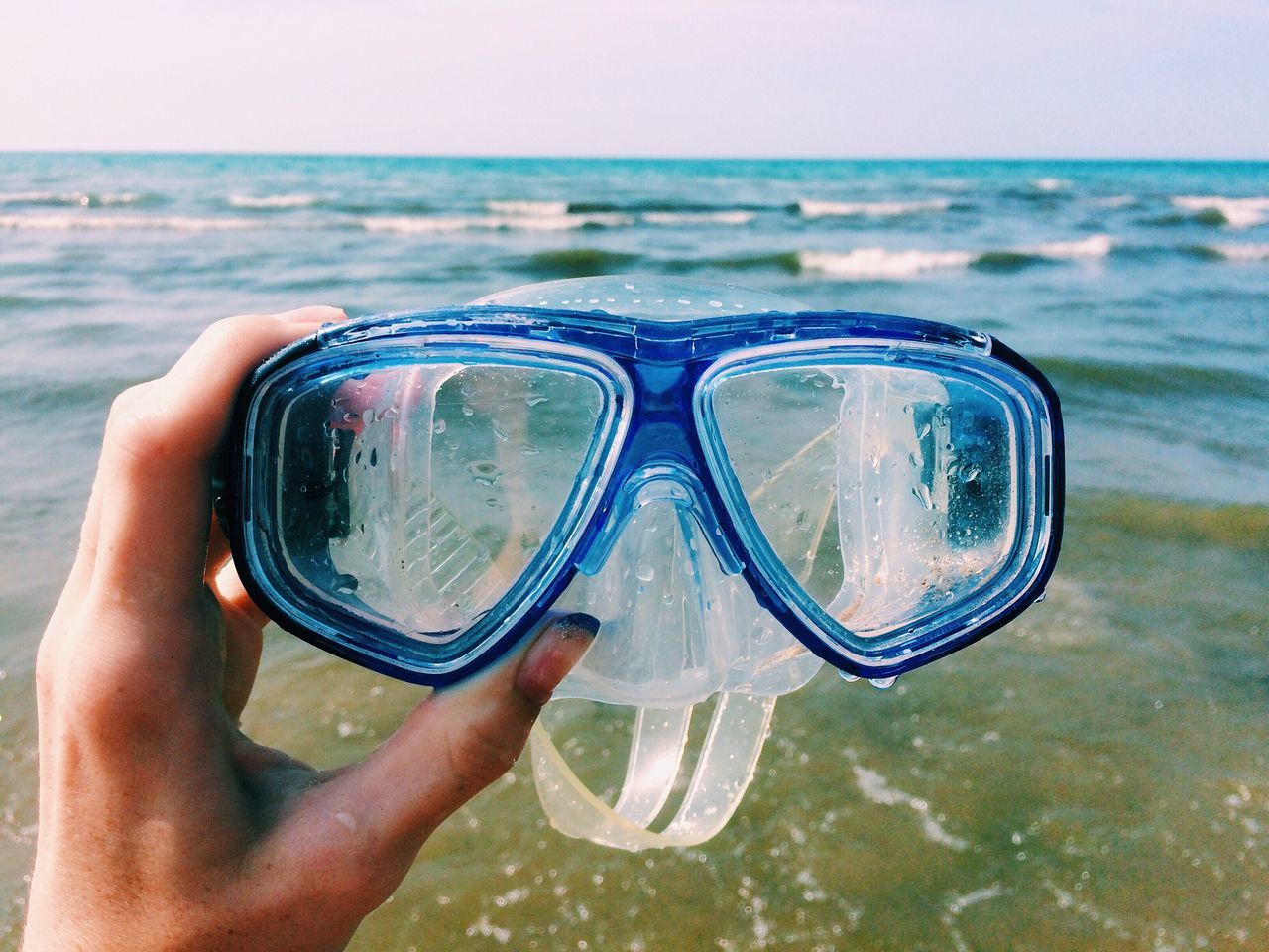 sea, real people, water, human hand, one person, human body part, holding, leisure activity, horizon over water, personal perspective, outdoors, close-up, day, beauty in nature, lifestyles, beach, nature, sky, people