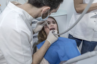 Midsection of doctor examining patient in hospital