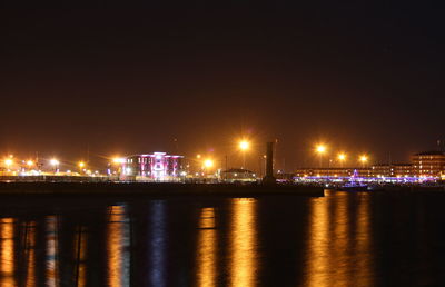 Illuminated city at waterfront