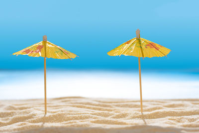 Umbrella on beach against clear sky