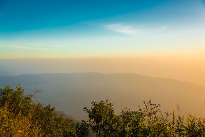 Scenic view of mountains against sky at sunset