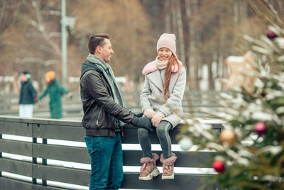 Side view of woman standing by railing