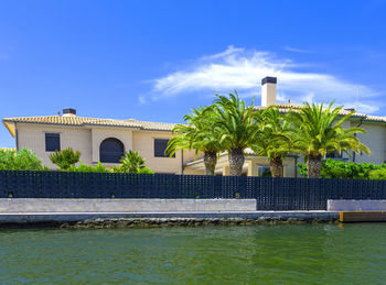 The house with palm by the water at the resort in spain