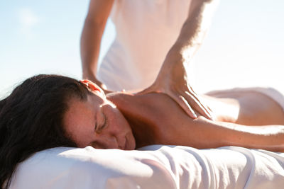 Side view of woman lying on bed