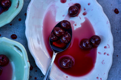  small white ceramic platter with sugar water cherry sauce and whole sour morello cherries