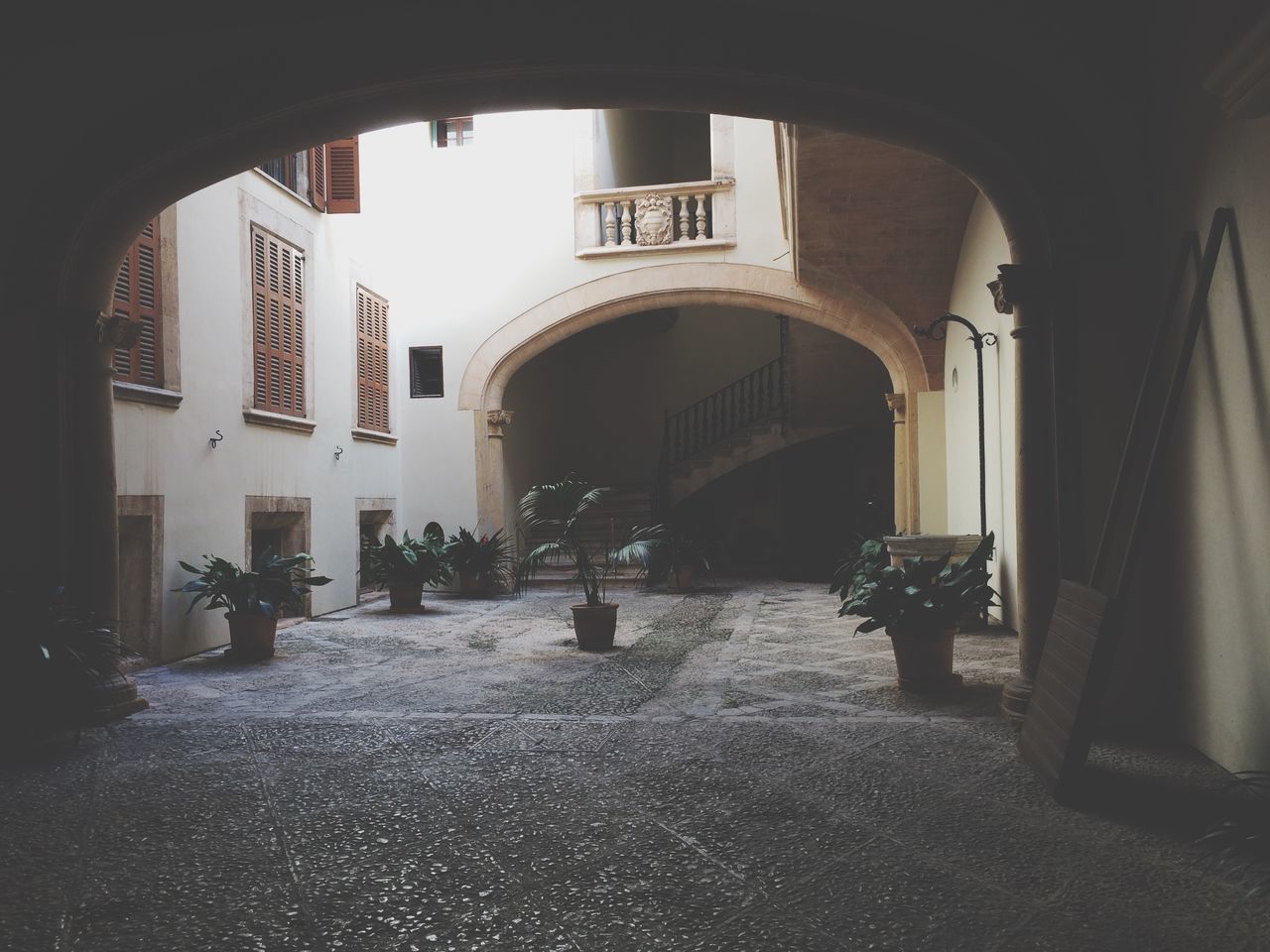 architecture, arch, built structure, indoors, building exterior, archway, the way forward, building, architectural column, window, men, person, arched, walking, day, corridor, incidental people, column, sunlight