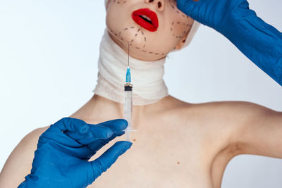 Woman holding syringe for beauty treatment