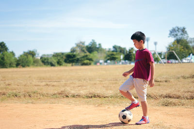 Boy playing soccer on field