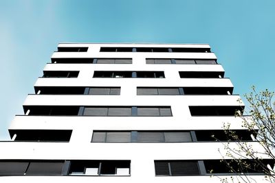 Low angle view of office building against clear sky