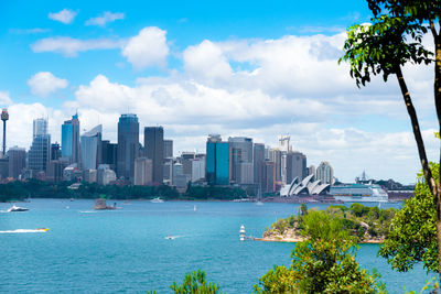 Scenic view of sea by buildings against sky