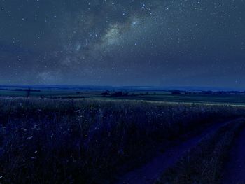 Scenic view of field against sky at night