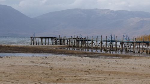 Pier over sea against mountains