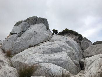 Low angle view of rock formation against sky