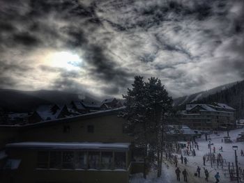 Snow covered mountains against cloudy sky