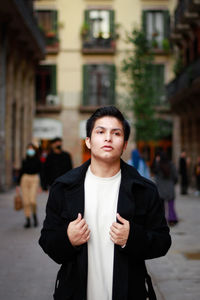 Portrait of young man standing outdoors