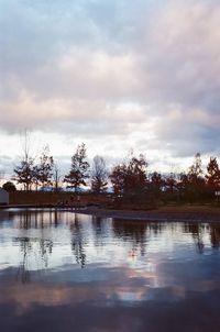 Reflection of trees in lake against sky