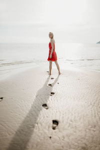 Full length of woman walking at beach