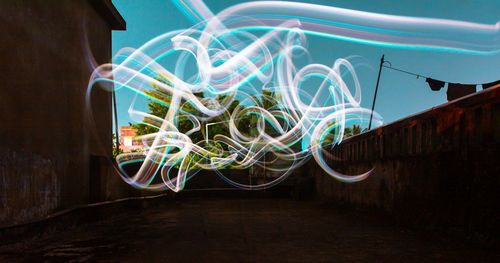 Multi colored light painting on wall in city at night