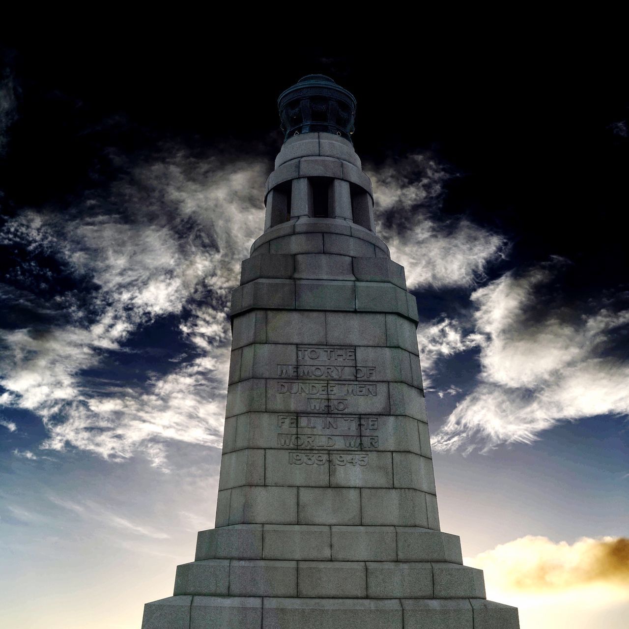 architecture, low angle view, built structure, sky, building exterior, tower, travel destinations, history, famous place, cloud - sky, tall, day, tall - high, outdoors, tourism, monument, cloudy, stone material, architectural column, no people, capital cities