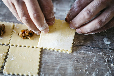 Cropped hands of male chef preparing food on table