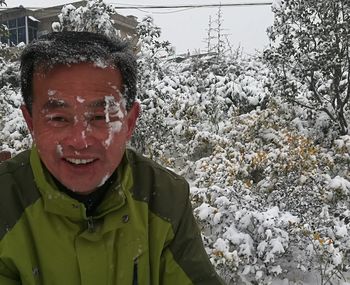 Close-up portrait of a boy in snow