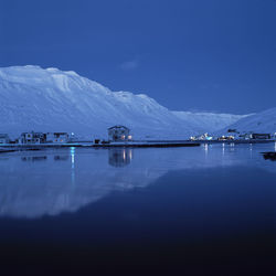 Houses reflecting in the fjord of the village syedisjordur in iceland