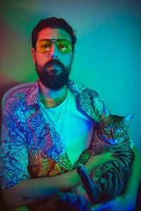 Portrait of man with cat