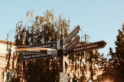 Low angle view of road sign against clear sky