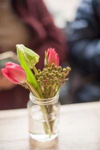 Close-up of flowers in glass on table