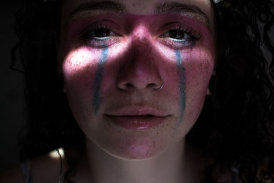 Close-up portrait of woman with face paint