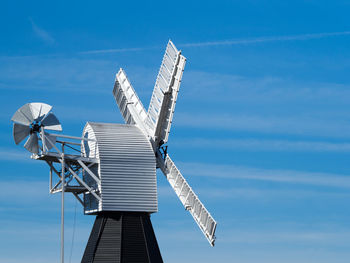 Low angle view of traditional windmill against sky