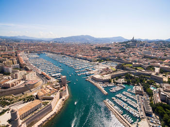 High angle view of buildings and sea against sky