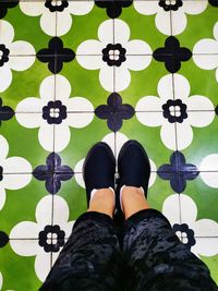 Low section of woman standing on tiled floor