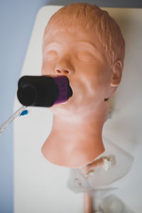 Close-up portrait of boy with toy in bathroom