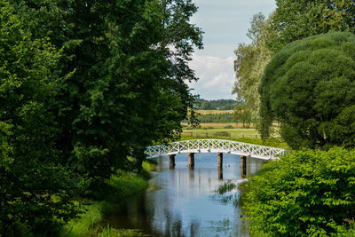 Arch bridge over river against sky