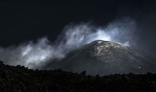 Low angle view of mountain against sky at night