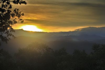 Scenic view of silhouette mountains against sky at sunset