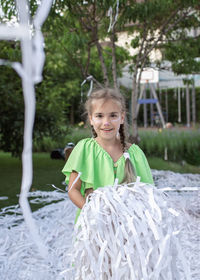 Portrait of smiling girl standing outdoors