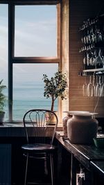 Potted plants on table by window at home