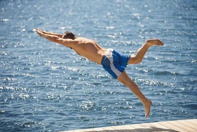 Side view of shirtless man in sea