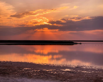 Scenic view of sea against romantic sky at sunset