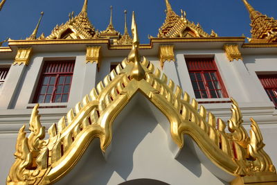 Low angle view of statues on building against sky