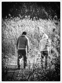 Full length of woman standing on tree trunk