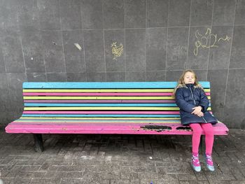 Rear view of man sitting on bench