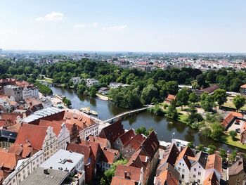 High angle view of buildings in town against sky