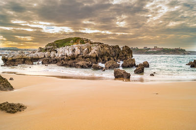 Scenic view of beach against sky during sunset