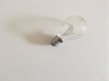 Close-up of light bulb against white background