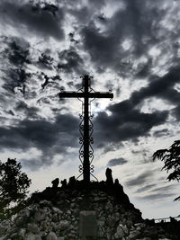 Low angle view of cross against sky