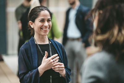 Portrait of young woman standing in city