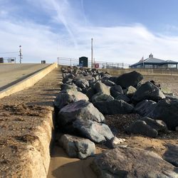 Rocks on beach against sky